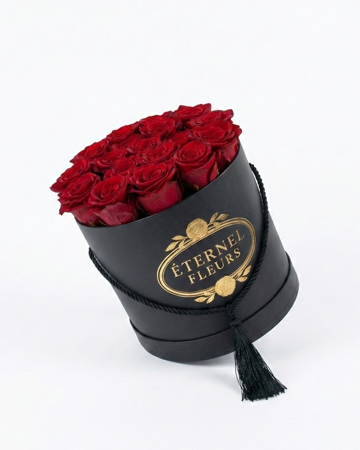 Black cylindrical box with red roses and 'Eternel Fleurs' logo on a white background